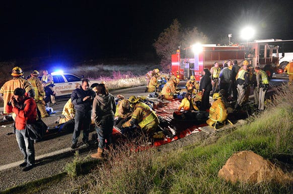 Authorities work the scene where at least eight people were killed and nearly two dozen were injured when a bus carrying a group from Tijuana, Mexico crashed with two other vehicles on its way back from Big Bear Lake on Highway 38 north of Yucaipa, Calif.