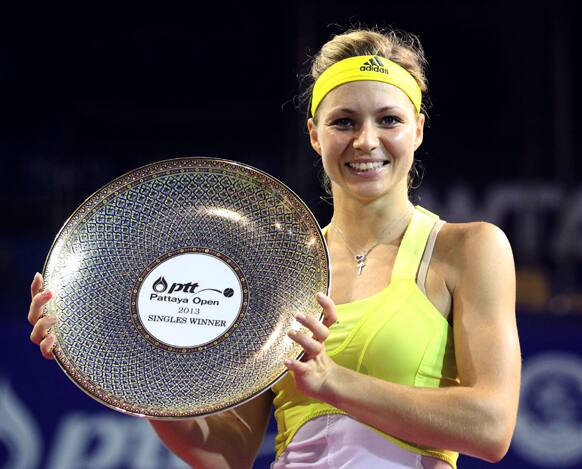 Maria Kirilenko of Russia poses with her trophy after winning the final match over Sabine Lisicki of Germany in the PTT Pattaya Open tennis tournament in Pattaya, Thailand.