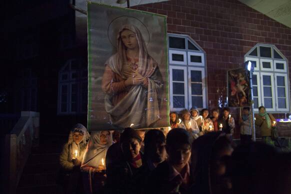 Catholic believers hold candles outside a church before they parade on the main roads in Laiza, chanting prayers for peace, in northern Myanmar`s Kachin-controlled region.