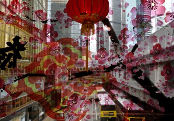 Chinese New Year decorations are displayed on a window at a shopping mall in Hong Kong, to celebrate the Year of the Snake as the Chinese lunar New Year starts on Feb. 10.