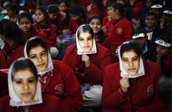 Indian schoolgirls wear masks of Malala Yousufzai, a 15-year-old girl who was shot at close range in the head by a Taliban gunman in Pakistan, during a campaign to demand better budgetary allocation for health and education of Indian children in New Delhi.