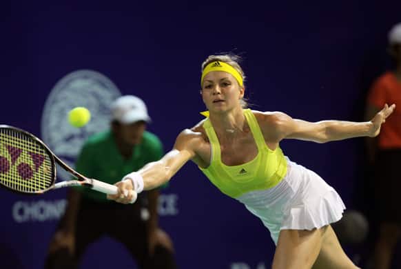 Maria Kirilenko of Russia returns a shot against Sorana Cirstea of Romania during their semifinal tennis match at the Pattaya Open tennis in Pattaya, Thailand.