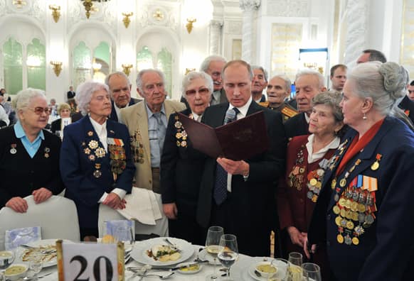 Russian President Vladimir Putin, center, meets with World War II veterans at a reception marking the 70th anniversary of the Battle of Stalingrad, in the Kremlin in Moscow, Russia.