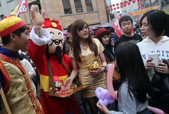 A man in costume gestures to lure customers to his stall at the Dihua Street market in Taipei, Taiwan.