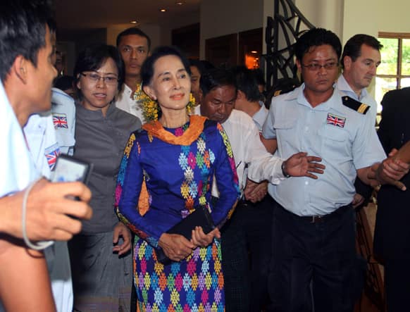 Myanmar opposition leader Aung San Suu Kyi, center, arrives for the second day of the Irrawaddy Literary Festival in Yangon, Myanmar.