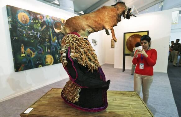 A woman takes photos of an art work by Shine Shivan at the 5th India Art Fair in New Delhi. 105 galleries are showcasing works of 1,000 artists from across the globe during the four-day art fair from Jan. 31.