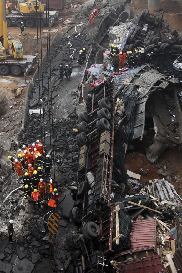 Rescuers work at the accident site where an expressway bridge partially collapsed due to a truck explosion in Mianchi County, Sanmenxia, central China`s Henan Province.