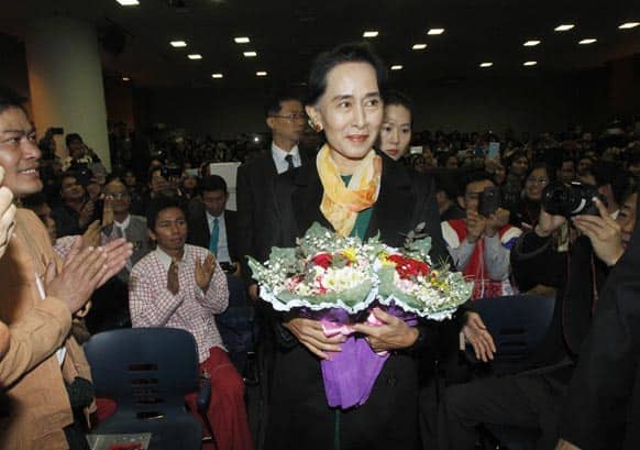 Myanmar`s opposition leader Aung San Suu Kyi is greeted by Myanmar nationals who live in South Korea upon her arrival at the former South Korean President Kim Dae-jung Library in Seoul.