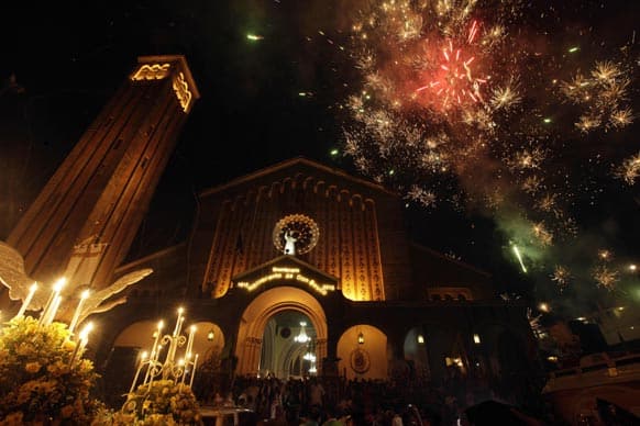 Fireworks explode over the Basilica Menor after a procession honoring St. John Don Bosco, Catholic Patron Saint of Magicians, in Panama City.