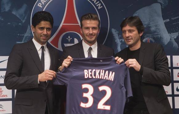 Paris Saint Germain`s President Nasser Al-Khelaifi, left, British soccer player David Backham, and Sports Director Leonardo, right, pose with Backham`s jersey during a press conference, in at the Parc des Princes stadium in Paris.