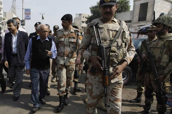 Pakistan army soldiers escort Fakhruddin Ebrahim, Chief Election Commissioner of Pakistan to verify lists of voters in Karachi.