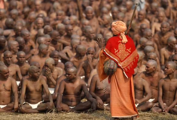 Hindu holy men of the Juna Akhara sect participate in rituals that are believed to rid them of all ties in this life and dedicate themselves to serving God as a `Naga` or naked holy men, at Sangam, the confluence of the Ganges and Yamuna River during the Maha Kumbh festival in Allahabad.