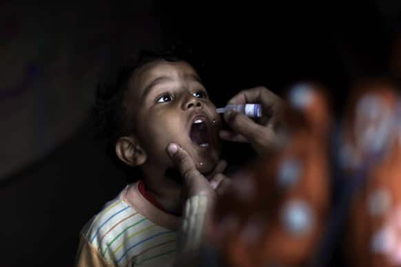Pakistani health worker Shahida Akram, 41, gives a polio vaccine to a child, in a neighborhood in Islamabad. Some Islamic militants oppose the vaccination campaign, accuse health workers of acting as spies for the U.S. and claim the polio vaccine is intended to make Muslim children sterile.