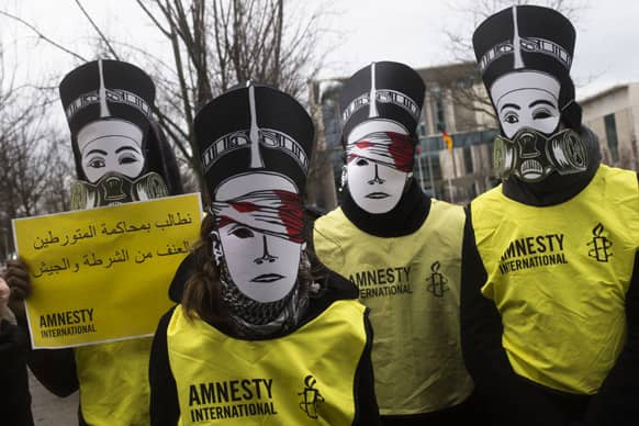 Activists of the human rights organization Amnesty International with Nefertiti masks protest in front of the chancellery against the visit of Egyptian President Mohammed Morsi prior to a meeting of him with German Chancellor Angela Merkel in Berlin.