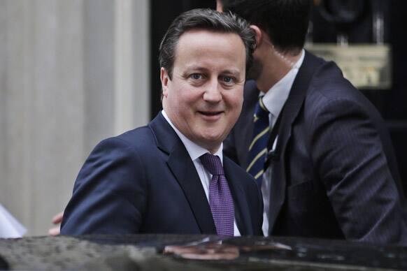 Britain`s Prime Minister David Cameron leaves his official residence at 10 Downing Street in central London, on his way to the Houses of Parliament to address lawmakers.
