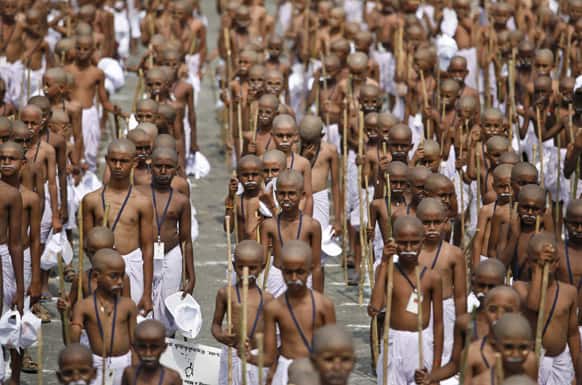 Children with their heads shaved and dressed like Mahatma Gandhi assemble at an event to mark his death anniversary in Chennai.
