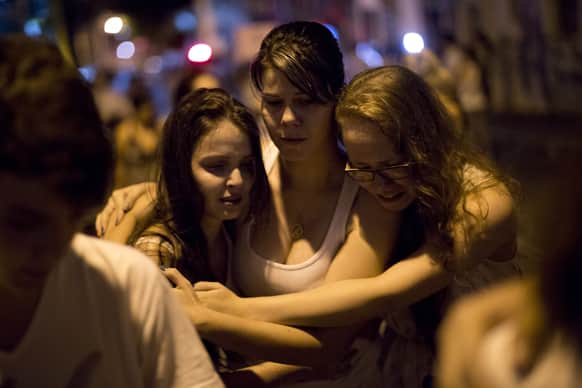 People react during a march near the Kiss nightclub honoring the victims of early Sunday`s fatal fire inside the club in Santa Maria, Brazil.