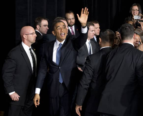 President Barack Obama waves as he leaves after shaking hands and speaking about immigration at Del Sol High School.