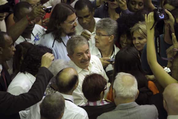 Brazil`s former President Luiz Inacio Lula da Silva, center, surrounded by journalists, arrives to attend the International Congress for World Balance in Havana, Cuba.