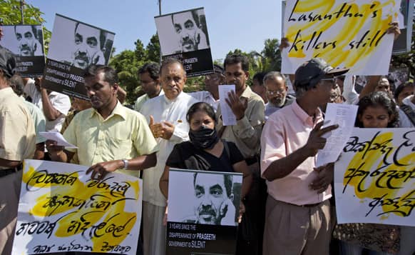 Journalists, rights activists and opposition lawmakers shout slogans and display placards during a demonstration alleging the government of suppression of media in Colombo.
