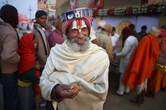 A Hindu holy man smiles as he walks back after receiving charitable food during the Maha Kumbh festival in Allahabad.