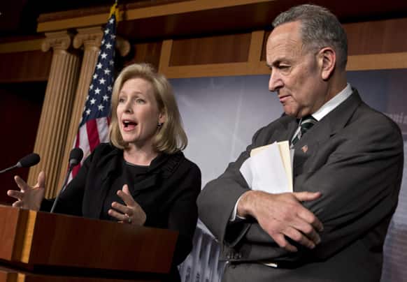 Sen. Kirsten Gillibrand, D-N.Y., left, and Sen. Charles Schumer, D-N.Y., right, react after the Senate passed a $50.5 billion emergency relief measure for Superstorm Sandy victims at the Capitol in Washington.