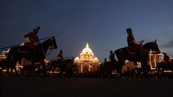 Horse mounted Indian presidential body guards return after full dress rehearsals of the Beating Retreat ceremony at Raisina hill which houses India`s most important ministries and presidential palace, in New Delhi.