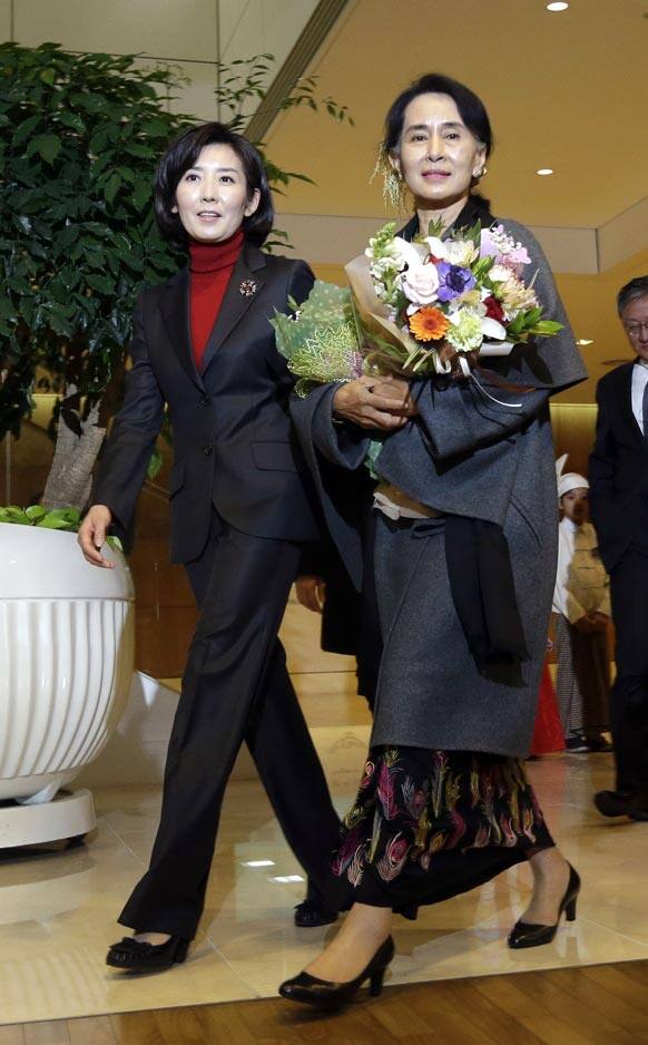 Myanmar opposition leader Aung San Suu Kyi, right, is escorted by the 2013 Pyeongchang Special Olympics Organizing Committee chairperson Na Kyung-won upon her arrival at Incheon International Airport in Incheon, west of Seoul, South Korea.