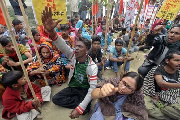 Bangladeshi garment workers shout slogans as they participate in a protest outside Bangladesh Garment Manufacturers and Export Association (BGMEA) building to mourn the death of the victims of a fire in a garment factory in Dhaka.