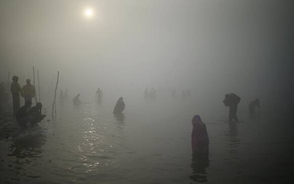 Hindu pilgrims take a dip at Sangam, the confluence of the Ganges, Yamuna and the mythical Saraswati River, during the Maha Kumbh festival in Allahabad.