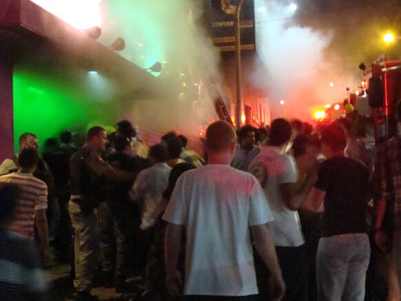 A crowd stands outside the Kiss nightclub during a fire inside the club in Santa Maria city, Brazil. A blaze raced through the crowded nightclub in southern Brazil early Sunday, killing 245 people as the air filled with deadly smoke & panicked party-goers stampeded toward the exits, police said.
