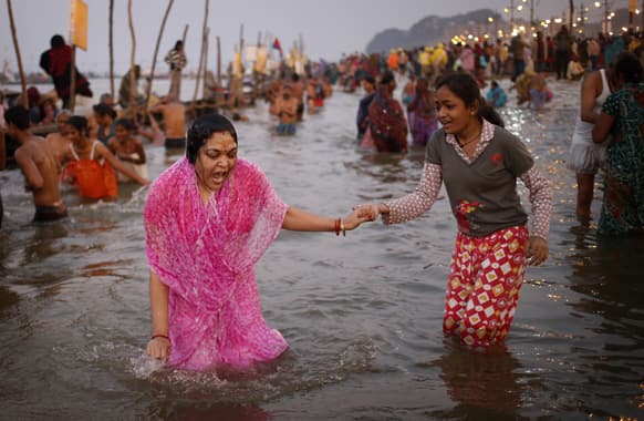 A Hindu devotee gasps after a dip in the cold water at