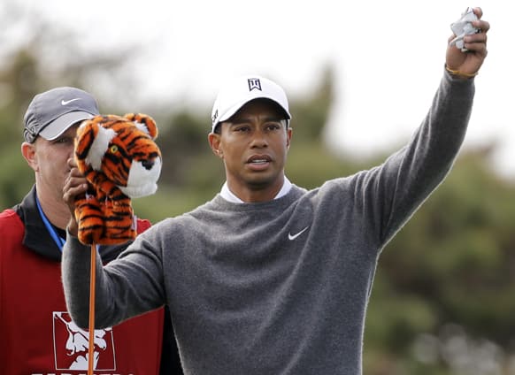Tiger Woods pulls his driver from the bag as he gets ready for his tee shot on the fourth hole at Torrey Pines during the third round of the Farmers Insurance Open golf tournament in San Diego.
