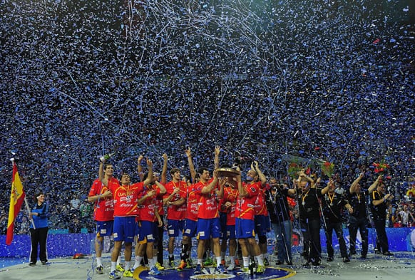 Spanish players raise the trophy after winning the final match of the Handball World Championships between Spain and Denmark at Palau Sant Jordi in Barcelona, Spain.