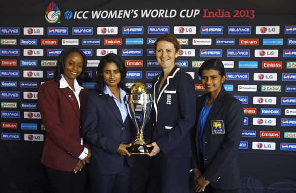 Captains of Women`s cricket teams from left, West Indies’ Merissa Aguilleira, India’s Mithali Raj, England captain Charlotte Edwards and Sri Lanka’s Shashikala Siriwardena pose with the ICC Women`s World Cup 2013 trophy in Mumbai.