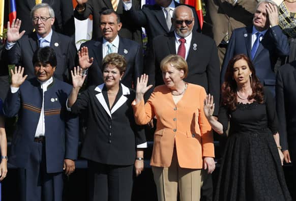 Bolivia`s President Evo Morales, from left to right, bottom row, Brazil`s President Dilma Rousseff, German Chancellor Angela Merkel, and Argentina`s President Cristina Fernandez, wave as they pose for the CELAC-EU summit official group photo in Santiago, Chile.