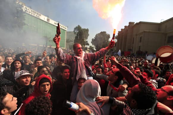 Egyptian soccer fans of Al-Ahly club celebrate a court verdict that returned 21 death penalties in last years soccer violence, inside the club premises in Cairo, Egypt.