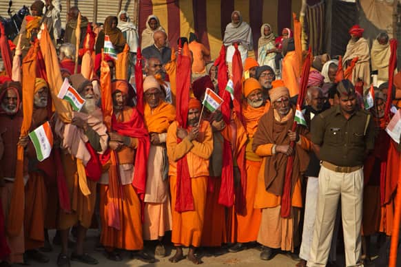 Sadhus, or Hindu holy men, hold national flags and celebrate India`s Republic Day at the Sangam, the confluence of the rivers Ganges, Yamuna and mythical Saraswati, during the Maha Kumbh Mela in Allahabad.