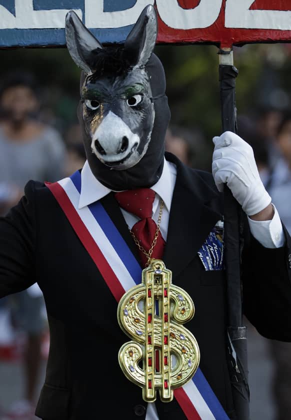 A man wears a donkey mask during a protest against politicians, corruption and the CELAC-EU summit in Santiago, Chile.