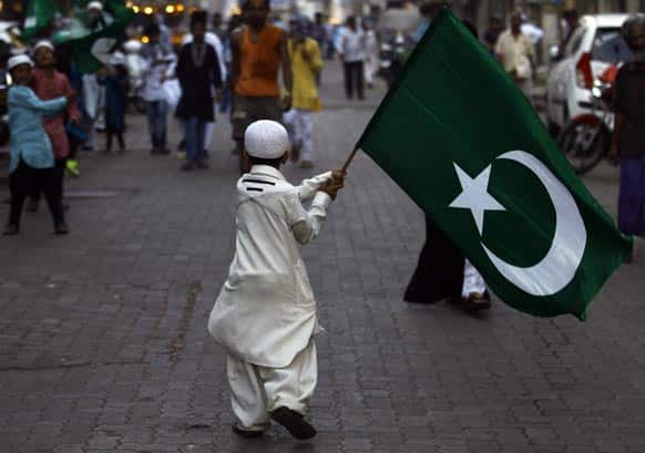 An Indian Muslim boy holds a religious flag and walks in a procession to mark the birth anniversary of Prophet Mohammed in Mumbai.