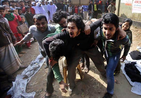 Bangladeshi activists perform a street play during a protest demanding punishment for the Tazreen Fashions factory owner and compensation for the victims outside the factory in Savar, on the outskirts of Dhaka.