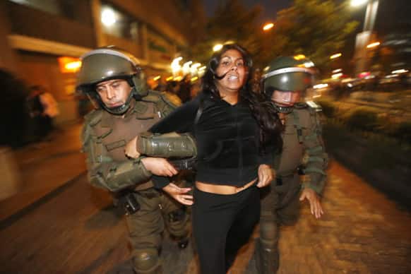 Police arrest a woman during a protest in support of Mapuche Indians, after protesters tried to block an avenue in Santiago, Chile. The Mapuches` demands for the return of their lands and autonomy date back centuries.