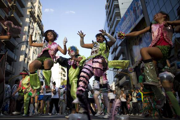 Members of murgas, groups of extravagantly dressed dancers and drummers that parade their way through the streets, perform ahead carnival celebrations along Corrientes Avenue in Buenos Aires, Argentina.
