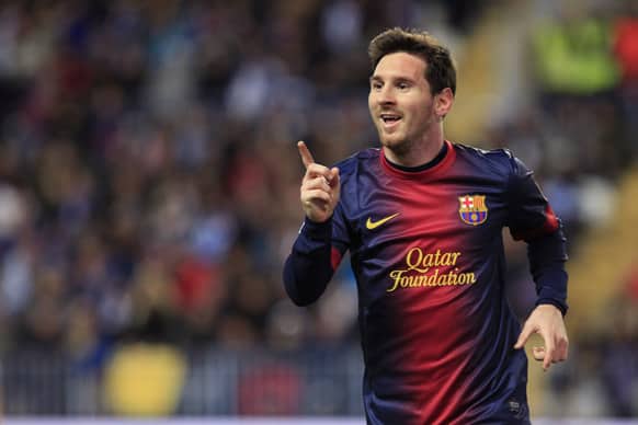 FC Barcelona`s Lionel Messi from Argentina reacts as he celebrates his goal against Malaga during a Copa del Rey soccer match at the Rosaleda stadium in Malaga, Spain.