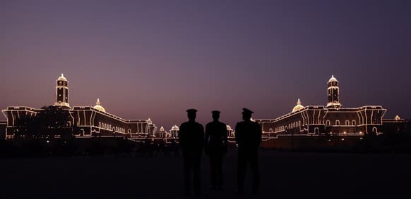 Members of military band rehearse for the upcoming Beating Retreat ceremony as workers, unseen, test the illumination at Raisina hill in New Delhi.