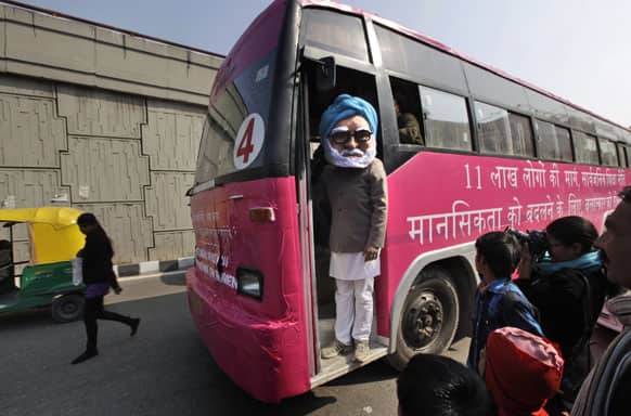 An activist dressed as Indian Prime Minister Manmohan Singh stands on a pink bus meant to spread awareness on violence against women, in New Delhi.