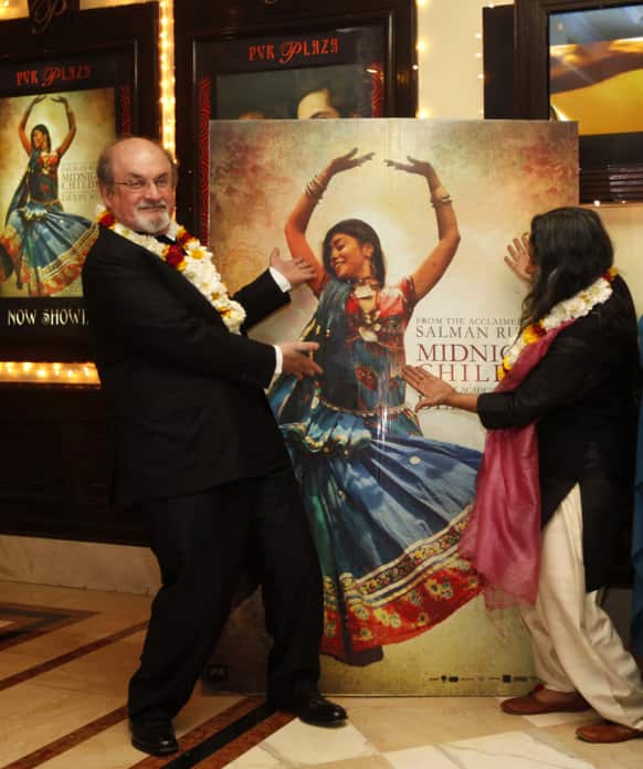 Author Salman Rushdie and director Deepa Mehta pose for the media before a screening of `Midnight Children` at a movie hall in New Delhi.