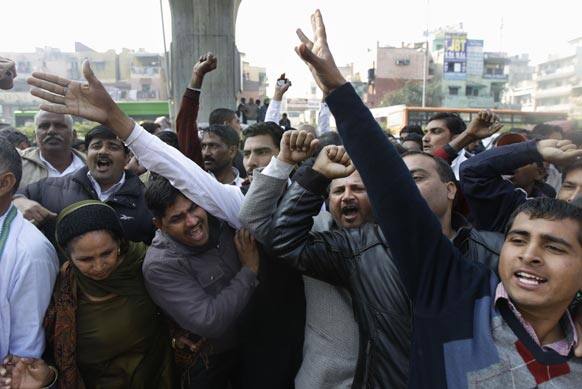 Supporters of former Haryana state Chief Minister Om Prakash Chautala shout slogans outside a court in New Delhi.