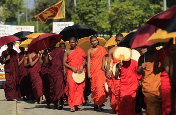 Sri Lankan Buddhist monks march towards the president`s residence demanding authorities to stop sending Sri Lankan women as maids to the Middle East following the recent beheading of a Sri Lankan maid by Saudi Arabia, during a protest in Colombo.