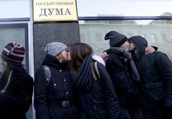 Gay rights campaigners kiss each other during a protest outside of State Duma, Russian Parliament`s lower chamber, in downtown Moscow.